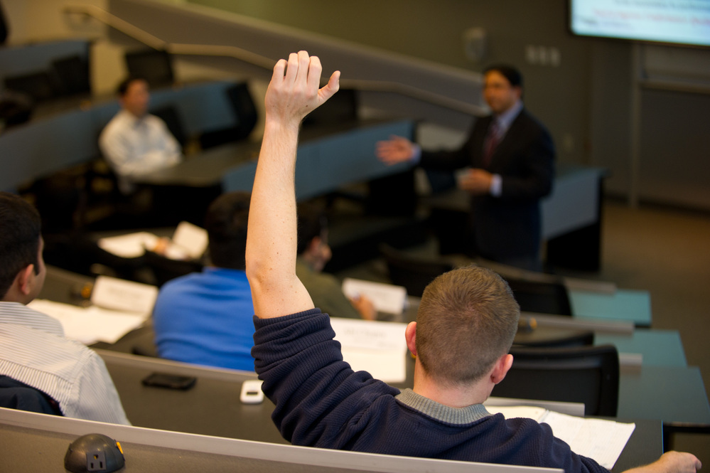 student with raised hand