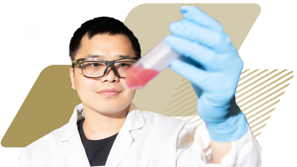 A student in a laboratory is wearing protective gear and holding a partially filled test tube