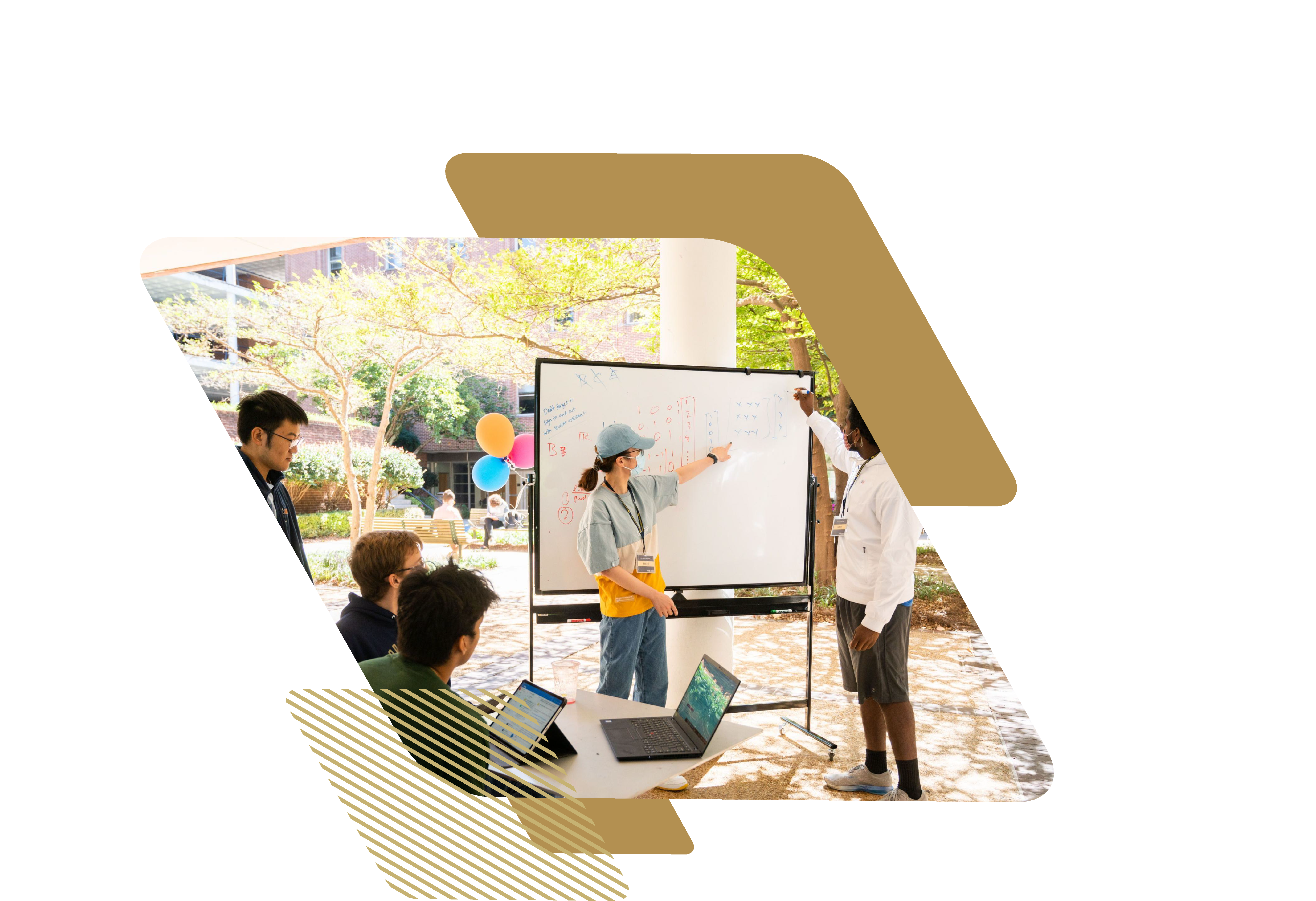 Students and teaching assistants discuss a problem written on a whiteboard during an outdoor “Math Lab” tutoring session