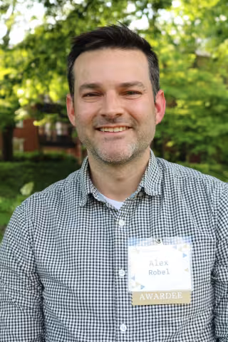 Headshot of a smiling man