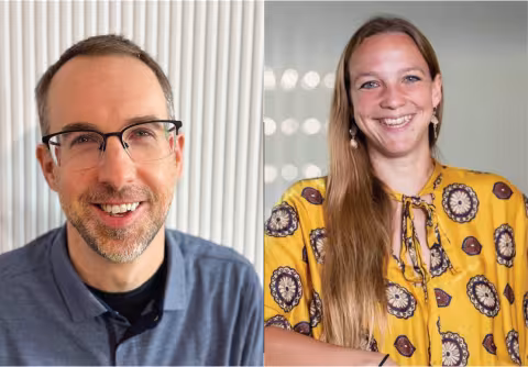 Side-by-side headshots of two people. On the left, a person with short brown hair, glasses, and a trimmed beard wears a blue collared shirt against a white textured background. On the right, a person with long brown hair wears a yellow patterned top against a softly blurred gray background.