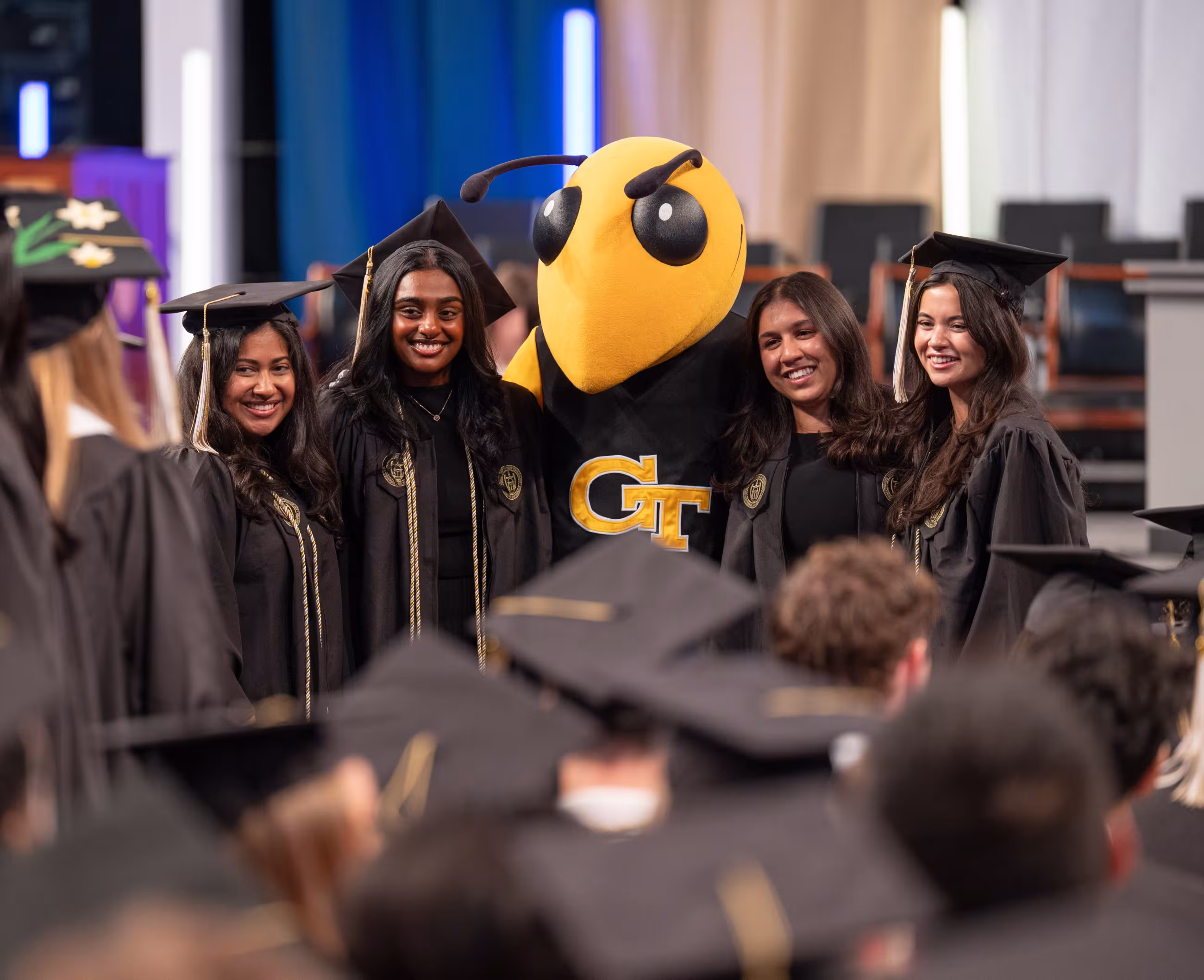 Graduates take photo with Buzz before Georgia Tech Commencement Ceremony